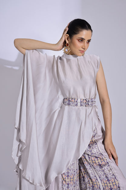 Asymmetric top paired with pleated pants